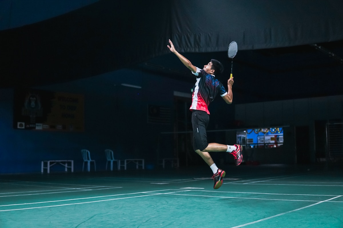 Coach guiding young athletes at charity sports clinic